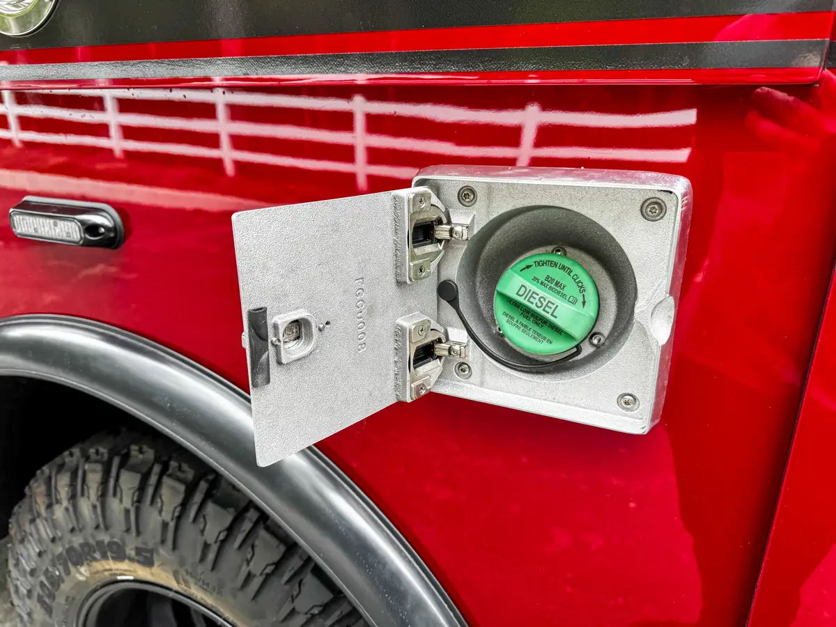 Closed fuel-fill door close-up on the side body panel.